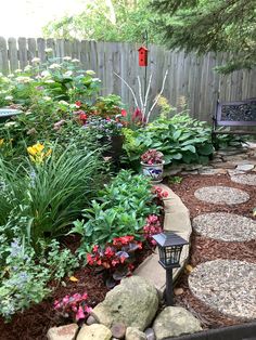 a garden with rocks and flowers in it