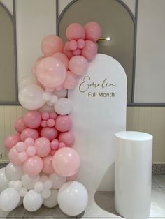 balloons are arranged in the shape of an arch for a balloon display at a wedding