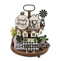 a wooden sign that says, simply home and welcome to the family with windmills on it