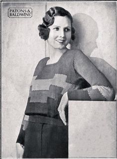 an old black and white photo of a woman wearing a sweater with squares on it