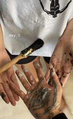 a person with their hands covered in mud and paint