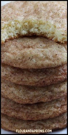 a stack of cookies sitting on top of a white plate covered in powdered sugar