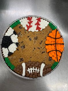 a football, basketball ball and other sports related items are arranged on top of a cookie sheet