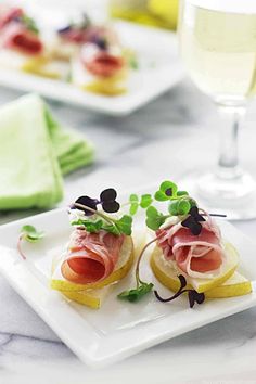 two slices of bread topped with meat and veggies on top of a white plate