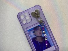 a cell phone case with a keychain attached to it and a photo on the back