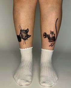 two people with tattoos on their legs, one has a mouse and the other has a cat