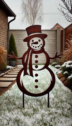 a metal snowman standing in the middle of a yard