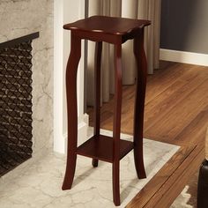 a wooden table with a shelf on it in front of a fireplace