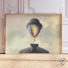 a man with a hat and tie is flying in a hot air balloon over his head