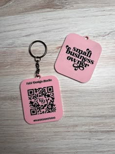 two pink tags with qr code printed on them