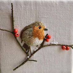 a small bird sitting on top of a tree branch with red berries around its neck