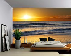 a bedroom scene with the sun setting over the ocean wallpaper mural print on the walls