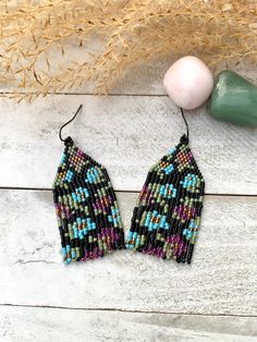 These black colorful floral fringe earrings are handwoven using Miyuki glass seed beads and paired with a black steel earwire. Earrings are approximately 2 3/4 inches in length ~shorter length earring and come with silicone backings. Earrings are simply packaged and placed in an organza bag for shipping. All designs, photos, and descriptions are property of TwistedRiverDesign! Black Tassel Earrings With Colorful Beads For Gift, Handwoven Black Beaded Dangle Earrings, Black Handwoven Dangle Earrings, Black Beaded Bohemian Tassel Earrings, Adjustable Black Beaded Tassel Earrings, Black Beaded Earrings With Ear Wire For Festival, Black Bohemian Tassel Earrings With Round Beads, Black Beaded Earrings For Festival, Bohemian Black Tassel Earrings With Round Beads