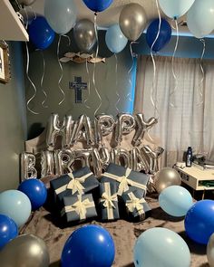 a birthday party with blue and silver balloons