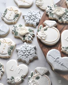 some decorated cookies are on a wooden board