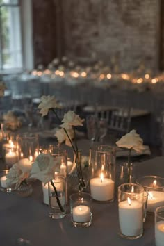 a table topped with lots of candles and flowers