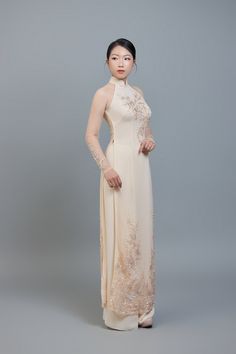 Custom made ao dai (Vietnamese traditional dress) champagne color chiffon (price includes pants worn underneath ao dai dress). After ordering we will send you a quick and simple form to guide you through taking the measurements we require for an amazing fit. Shipping details: Please allow 3-4 weeks for custom making and shipping, once measurements are received. Colors: Please note; we make every effort to ensure our photos accurately represent the true colors of each garment, but due to the natu Champagne Ao Dai, Traditional Beige Lace Dress, Elegant Ao Dai With Lace Sleeves For Wedding, Elegant Wedding Ao Dai With Lace Sleeves, Traditional White Ao Dai For Party, Fitted Wedding Ao Dai With Intricate Embroidery, Elegant Beige Gown For Ceremony, Ceremonial Fitted Ao Dai With Intricate Embroidery, Fitted Ao Dai With Intricate Embroidery For Ceremony