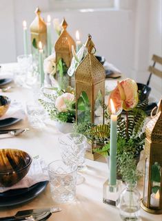 the table is set with candles and plates