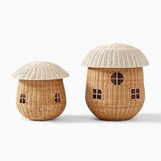 two wicker houses with an umbrella on the top and one in the middle, both made out of bamboo