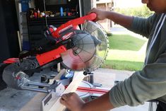 a man using a circular saw to cut wood