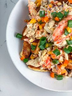 a white bowl filled with food on top of a table