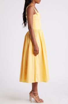 Sweet ribbon is threaded through tonal eyelets along the bodice of this sunny yellow midi dress with patch pockets along the playfully flared skirt. Exclusive retailer Back zip closure Square neck Button straps Front patch pockets Lined 98% cotton, 2% spandex Dry clean Imported Summer Cotton Midi Dress With Full Skirt, Summer Midi Dress With Full Skirt For Daywear, Summer A-line Midi Dress With Gathered Skirt, Spring Sundress With Gathered Skirt, Spring Midi Dress With Gathered Skirt, Yellow A-line Midi Dress For Garden Party, Yellow Cotton Midi Dress For Garden Party, Spring Midi Dress With Full Skirt, Spring Midi Dress With Full Skirt For Daywear