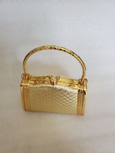 "This listing is for a small elegant Top Handle Clutch with embossed flowers and triangle vinyl exterior. On the sides it has 2 deep carved scrolls with the vinyl appearing through. It has a gold metal ornate handle and round over the top clasp. The interior is in a black fabric with a zippered pocket at the center. Clean and no stains. It has a gold tone specialty chain for a shoulder wear. The purse appears to have never been used and was found at The Brass Armadillo Antique Mall. If you are p Vinyl Exterior, Perfect Purse, Black Liner, Patterned Vinyl, Gold Hand, Jewelry Pins, Triangle Pattern, Gold Top, Antique Mall