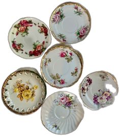 five plates with flowers on them sitting next to each other