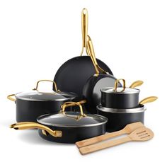 an assortment of pots and pans with wooden utensils