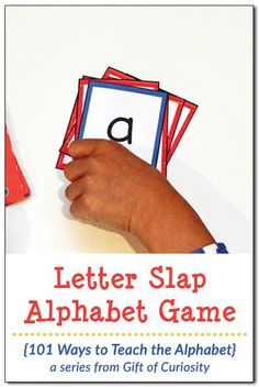 a hand holding up a letter slap alphabet game