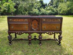 an old wooden dresser sitting in the grass