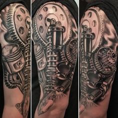 a man's arm is covered in black and grey tattoos with a motorcycle engine on it