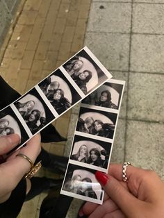 two women holding up polaroid photos with their hands on the ground next to each other