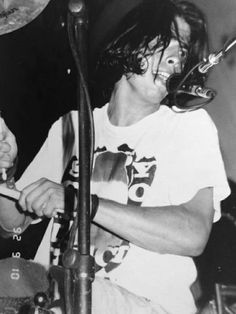 black and white photograph of a man playing drums