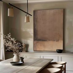 a dining room table with four chairs and a large painting on the wall