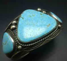 ". VINTAGE NAVAJO BRACELET DESCRIPTION: This bracelet features a trio of radiant Kingman watwerweb turquoise cabochons set on heavy gauge, hand-stamped sterling silver. This enchanting bracelet will be a cherished addition to your collection of fine vintage Native American jewelry. MEASUREMENTS: Interior of the cuff measures 5 3/8\" with an additional 1\" non-adjustable gap. Total circumference: 6 3/8\" Measures 2 1/4\" straight across the widest part (from wrist bone to wrist bone) Bracelet fac Formal Turquoise Engraved Jewelry, Classic Hallmarked Turquoise Jewelry, Bone Bracelet, Bones Bracelet, Vintage Native American Jewelry, Navajo Bracelet, Turquoise Bracelet Cuff, Turquoise Cuff, Vintage Navajo