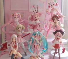 some anime figurines are on display in a room with pink walls and flooring