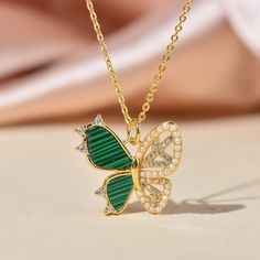 14K Gold plated Over Brass Micro Pave Dainty  Butterfly  Charm with sparkly Cubic Zirconia And Malachite Inlay. *CHAIN IS NOT INCLUDED Size: 20mm x 19mm Charm Thickness: 2.5mm Jump Ring : Open, Inside Diameter:3mm Color: Gold Bulk discount is available at drop down menu Ship from Los angeles Green Necklaces With Rhinestones As Gift, Green Rhinestone Jewelry For Gift, Green Rhinestone Necklace For Gift, Green Butterfly Jewelry For Gifts, Green Butterfly Jewelry For Gift, Gold Plated Green Jeweled Jewelry, Malachite Butterfly, Dainty Butterfly, Jewelry Lookbook