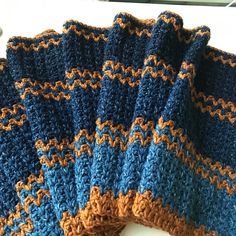 four crocheted dishcloths sitting on top of a white table