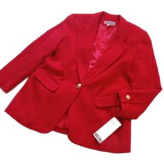 This Single Button, Wool Blend Red Blazer Has Medium Thickness Shoulder Pads And Gold Tone Buttons. It Has Faux Pockets In The Front. Size 14 Armpit To Armpit (Buttoned): 21.5" Sleeve Length (Top Of Shoulder To Wrist): 25" Length (Top Of Shoulder To Bottom Hem): 31.5" Material: Shell: 80% Wool, 20% Nylon. Lining 100% Polyester. Red Notch Lapel Outerwear With Buttons, Red Button-up Formal Outerwear, Red Single Button Outerwear For Work, Elegant Red Outerwear With Button Cuffs, Elegant Red Blazer With Button Closure, Red Business Outerwear With Buttons, Red Button-up Formal Blazer, Red Button-up Blazer For Formal Occasions, Elegant Solid Blazer With Snap Buttons