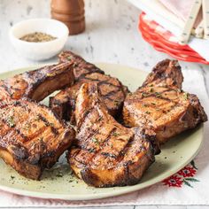 grilled steaks on a plate with lettuce and seasoning