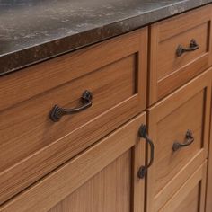 an image of a kitchen counter top that is made out of wood and has metal handles