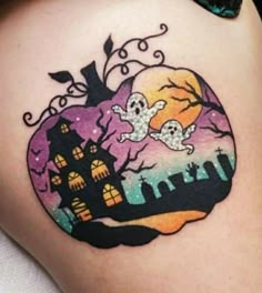 a woman's thigh with halloween tattoos on it