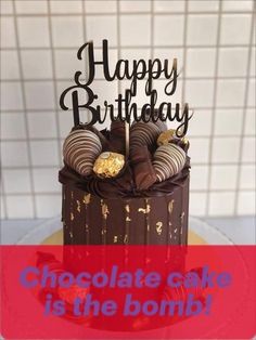 a chocolate cake is decorated with gold foil and has the words happy birthday written on it