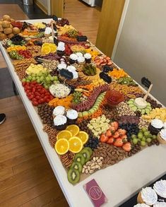 a table covered with lots of different types of fruits and vegetables on it's sides