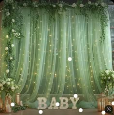 a baby shower with lights and greenery