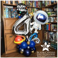 a bunch of balloons that are sitting in front of a book shelf filled with books