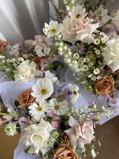 a bunch of flowers sitting on top of a table