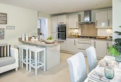 a kitchen and dining room with white furniture