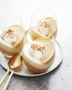 three desserts are sitting on a plate with spoons